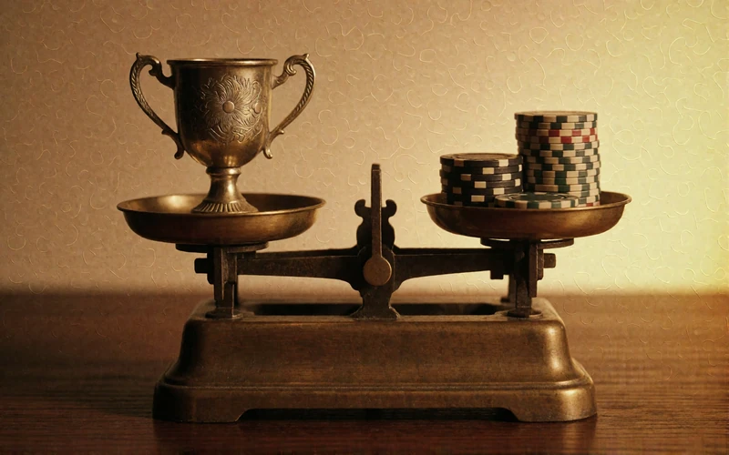 Waage mit Troph&auml;e und Casino-Chips als Sinnbild f&uuml;r die Abw&auml;gung von Vor- und Nachteilen bei BetScore